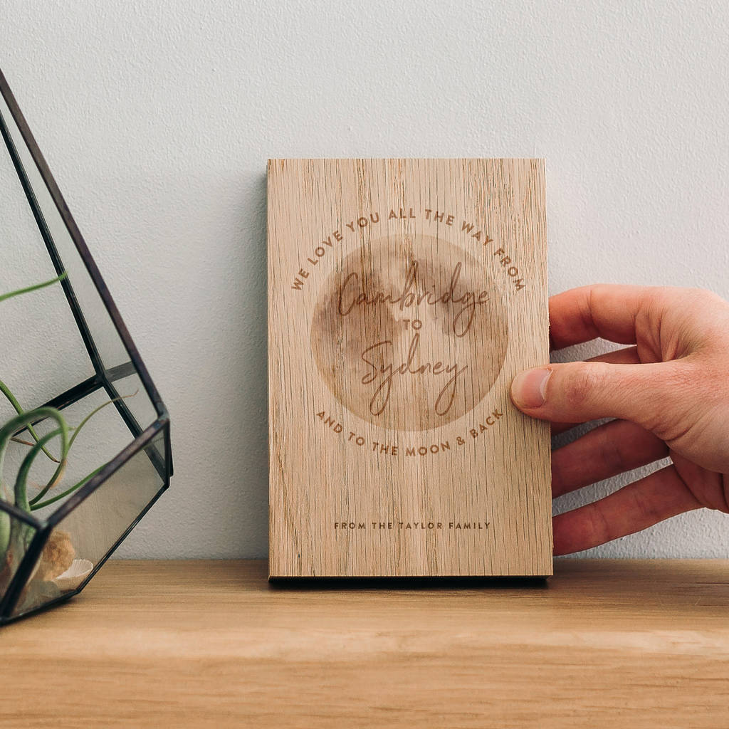 An oak wooden block with the words 'we love you all the way from Cambridge to Sydney and to the moon and back' featured around a picture of the moon. Underneath are the words 'from the Taylor family'. The photo is from further away.