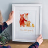 A custom bear family print in a white frame: The watercolour style illustrated family of bears show two parent bears, a child, and a baby bear. Underneath the customised words say 'Our little family - since 2016.'