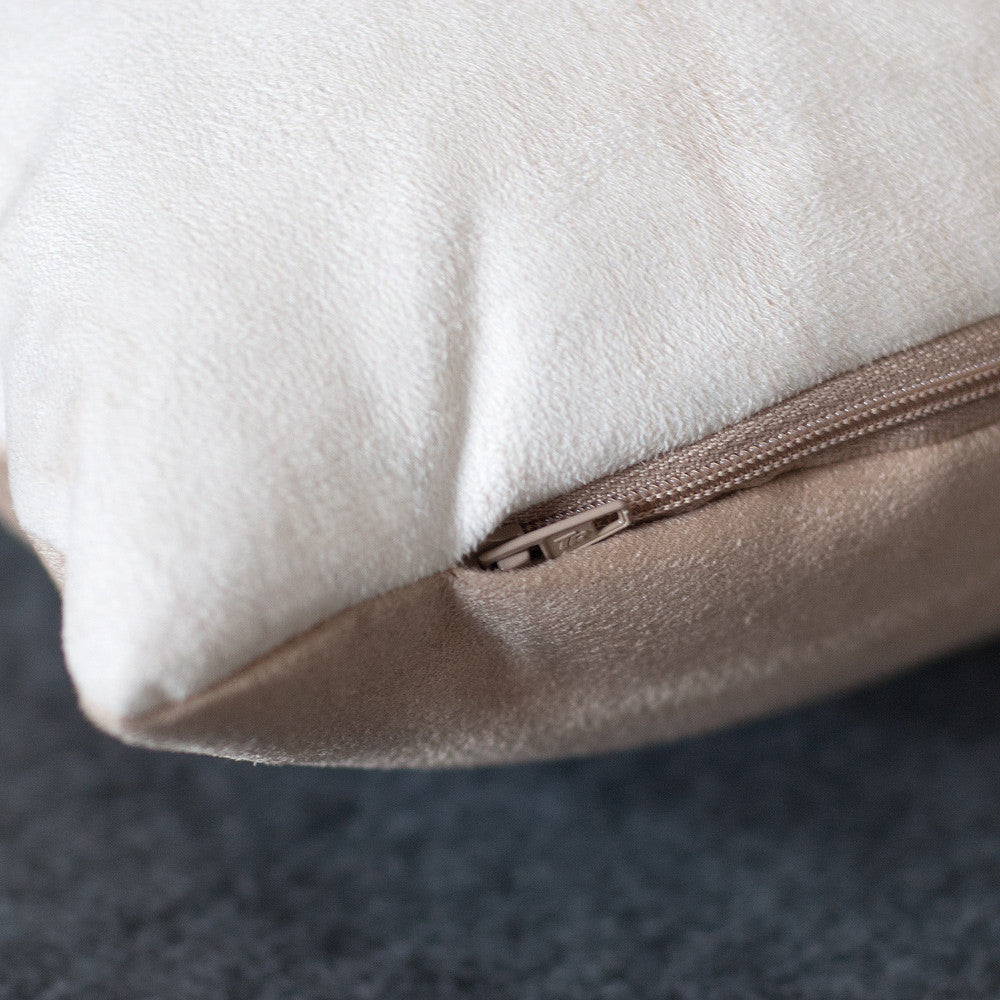 A close up image of the zip detailing, showing the concealed zip tucked into the fabric. The zip matches the beige backing fabric.