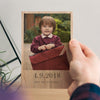 The image showcases a personalised photo block with a photo of a school child holding his school book bag printed on it. Underneath the photo on the block are the words '4.9.2018, First day at school'.