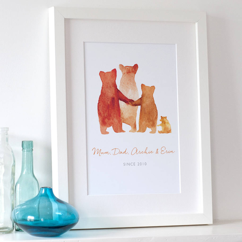 A personalised family bear print in a white frame: The watercolour style illustrated family of bears show two parent bears, a medium bear, and a baby bear. Underneath the customised words say Mum, Dad, Archie & Erin - SINCE 2010'.