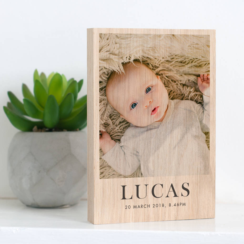 The image showcases a personalised photo block with a photo of a new born baby printed on it. Underneath the photo on the block are the words 'Lucas, 20 March 2018 8.46PM'.